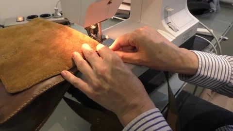 Sewing zipper into leather bag Stock Footage 137411756