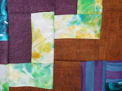 Sewn fragment of patchwork from various fabrics Stock Photos