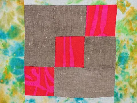 Sewn patchwork cloth from red and brown fabrics Stock Photos