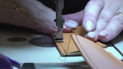 Sews leather on a sewing machine Stock Footage 267971137
