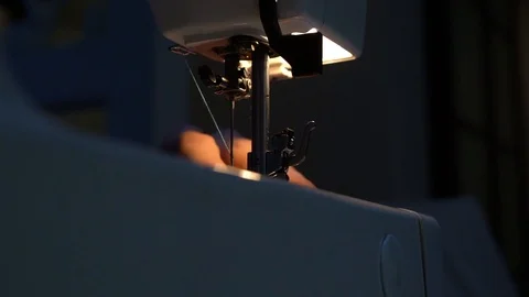 Sews at night on a sewing machine 库存影片 119071640