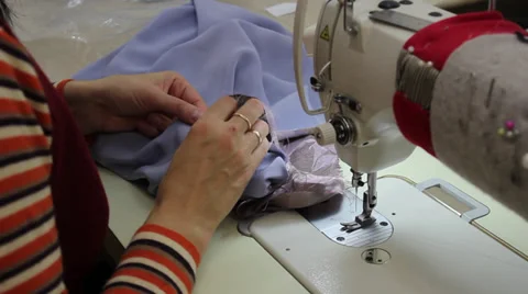 Sews on sewing machine 12 Stock Footage 33456899
