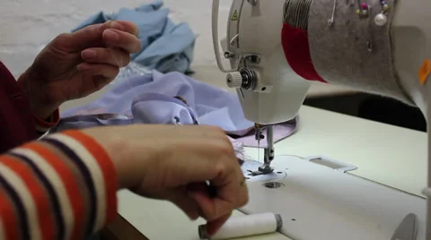 Sews on sewing machine 14 Stock Footage 33459735
