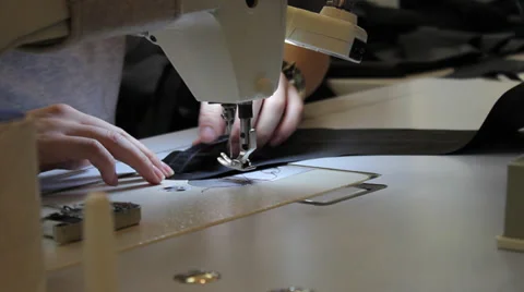 Sews on sewing machine 2 Stock Footage 33307373