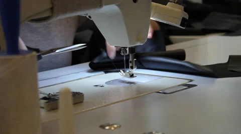 Sews on sewing machine Stock Footage 33307092