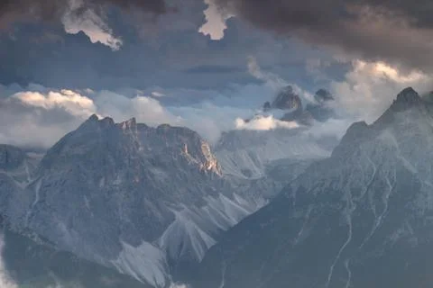 Sexten Dolomites in clouds illuminated by setting sun in Italy Stock Photos