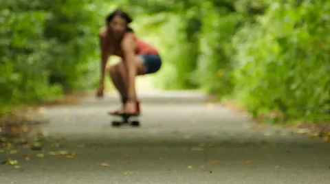 Sexual girl with skateboard go summer park. Slow motion Stock Footage