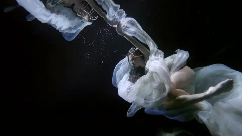 Sexual lady is floating slowly inside water of swimming pool, flowing white Video stock 167308697