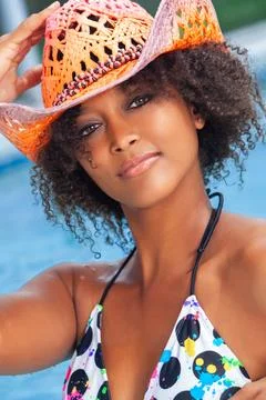 African American Girl in Swimwear Resting on Ocean Beach. Young