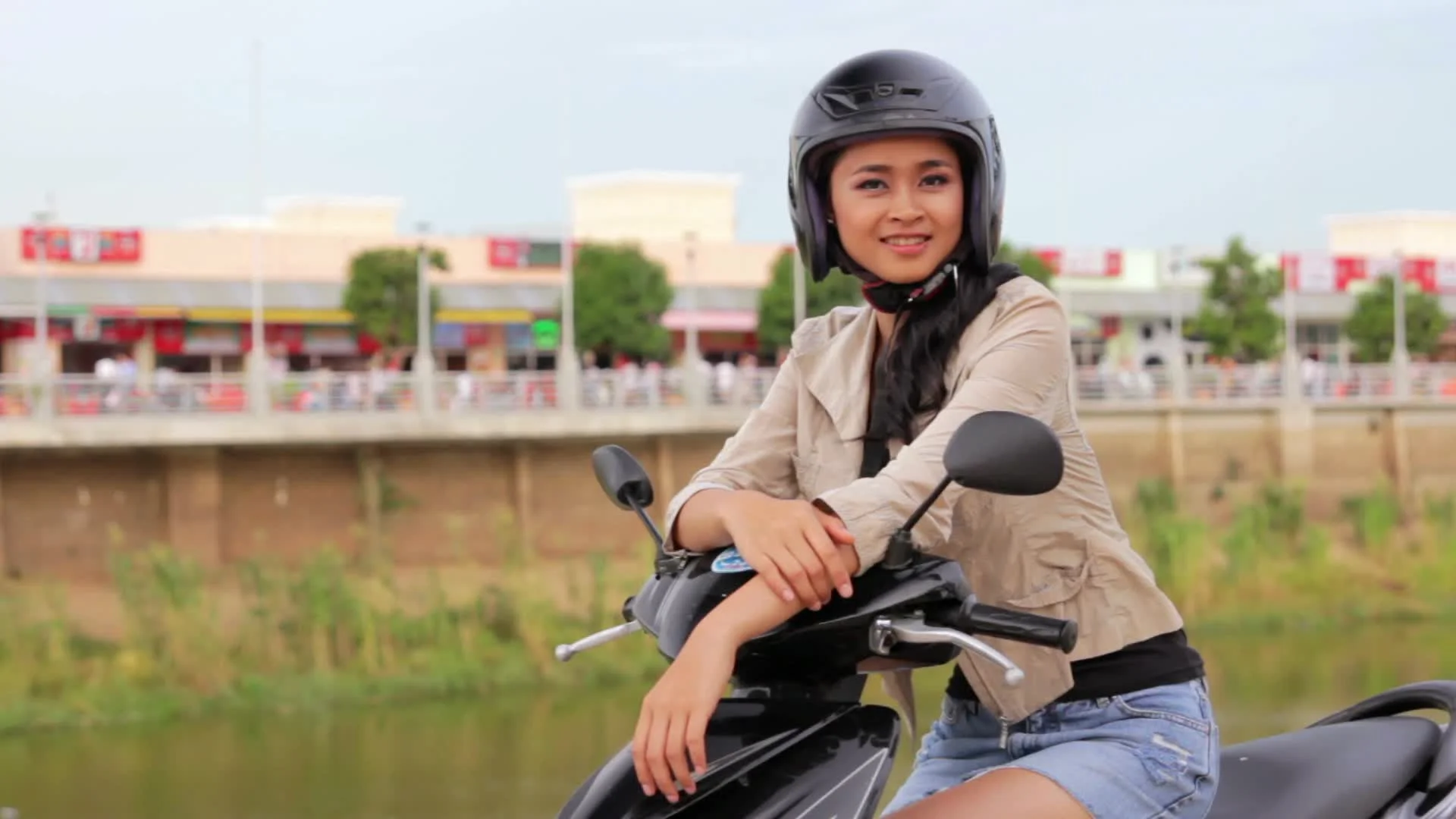 sexy asian girl with mini skirt, helmet, motorcycle in cambodia