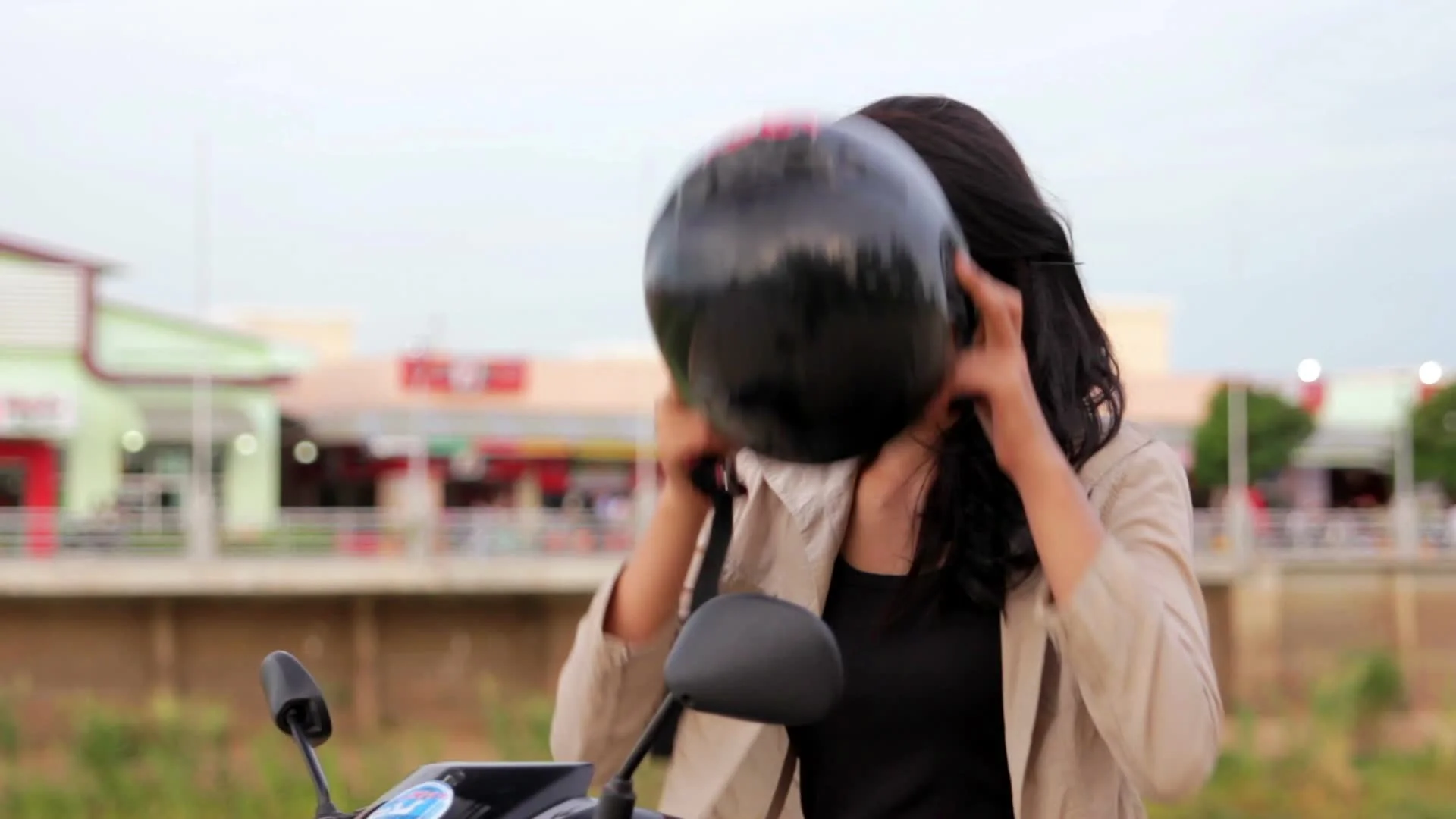 sexy asian girl with mini skirt, helmet, motorcycle in cambodia