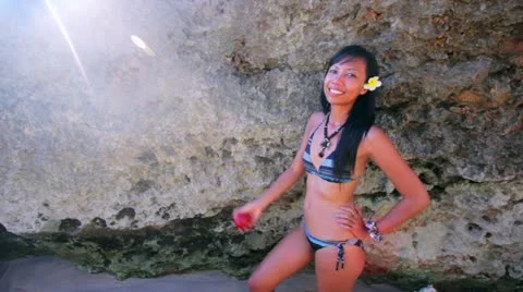 Sexy asian girl sustains her apple fruit diet at beach Stock Footage