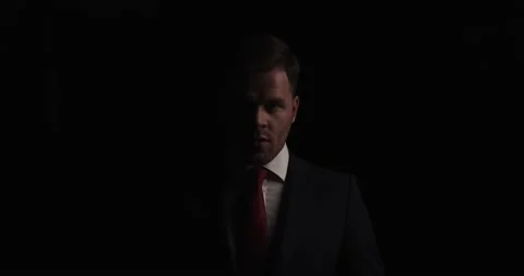 Sexy bearded businessman in elegant suit standing in a shadow, being mysterious, Stock Footage