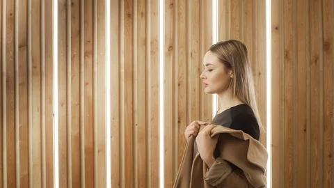 Sexy beautiful young multi-ethnic white woman puts on her coat and go away Stock Footage 110783353