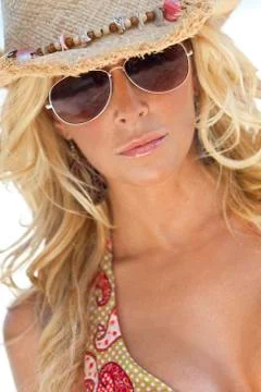 Sexy blond girl in aviator sunglasses and straw cowboy hat Stock Photos