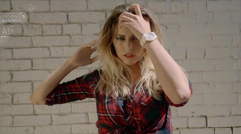 Sexy blonde model posing on brick wall background Stock Footage 67658966