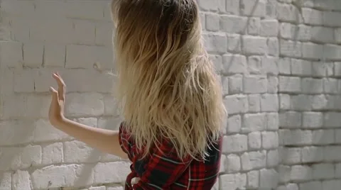 Sexy blonde model posing on brick wall background Stock Footage