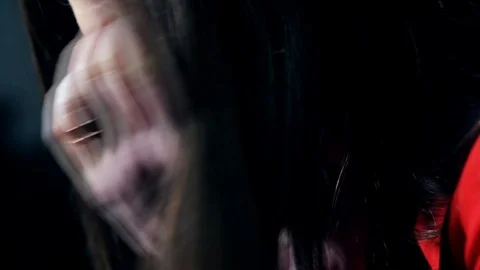 Sexy brunette with bright make-up and red juicy lips is lying on a leather sofa Stock Footage 102577458