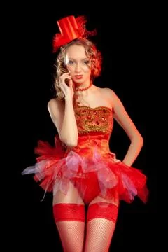 Sexy burlesque dancer stripper posing in red corset and red hat with curly ha Stock Photos