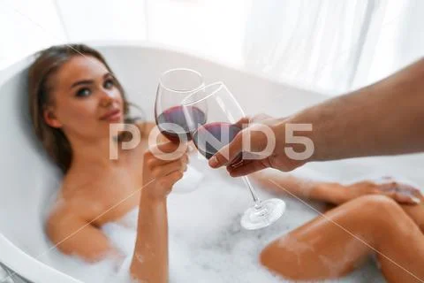 Side view of female sexy body with soap foam indoors in bathroom