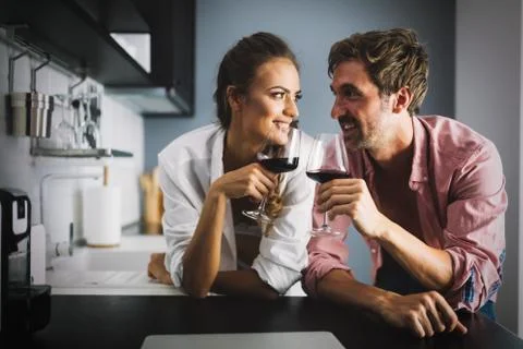 Sexy couple looks at a recipe in laptop, cooking Stock Photos