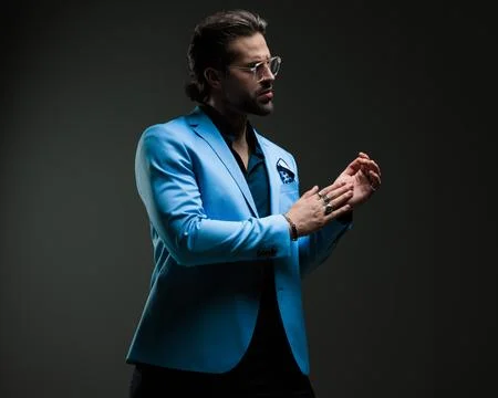 Sexy dramatic man with glasses looking to side and rubbing palms Stock Photos