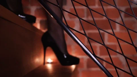 Sexy female legs walking down the stairs in high heels close-up. Romantic Stock Footage 123760805