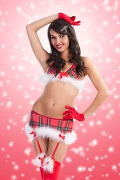 Sexy girl in red christmas costume dress with short skirt and red stocking we Stock Photos