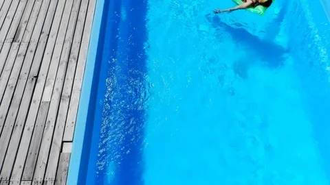 Sexy girl resting on pool float in swimming pool in summer 動画素材 127002620