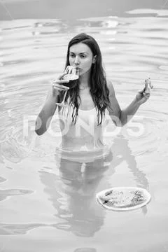 Sexy girl with watermelon and wine in pool Stock Photos