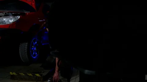 Sexy Guy Fixing the Wheel Stock Footage 75861278