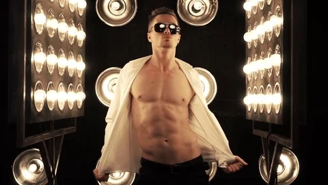 Sexy man dancing on the background of lights Video stock 83717345