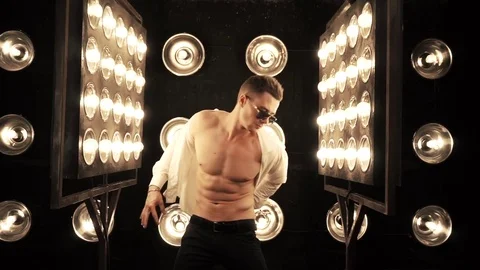 Sexy man dancing on the background of lights Video stock 83717373