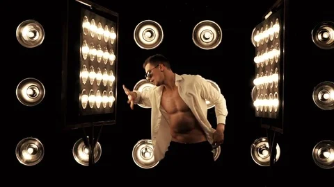 Sexy man dancing on the background of lights Video stock 83730022