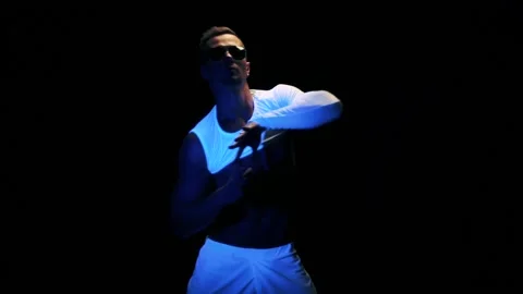 Sexy man is dancing on black background Stock Footage 92376084