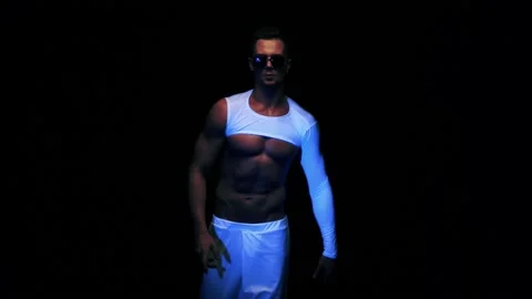 Sexy man is dancing on black background Vídeo Stock 92376402
