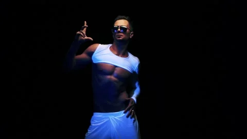 Sexy man is dancing on black background 스톡 동영상 92376803