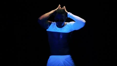 Sexy man is dancing on black background Stock Footage 92377003