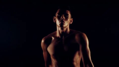 Sexy man is dancing on black background Stock-Footage 93309466