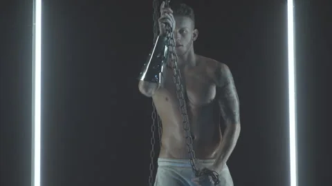 Sexy man dancing with chains in smoke Stock Footage 145942441