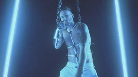 Sexy man dancing with chains in smoke Stock Footage 145946658