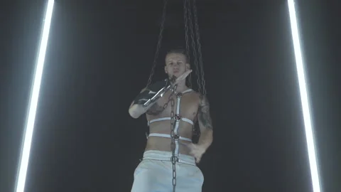 Sexy man dancing with chains in smoke Stock Footage 145947171