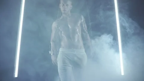 Sexy man dancing with chains in smoke Stock Footage 145954693