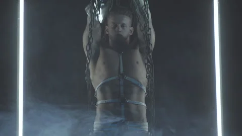 Sexy man dancing with chains in smoke Stock Footage 146298618