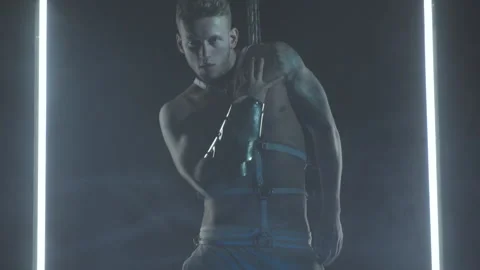 Sexy man dancing with chains in smoke Stock Footage 146298743
