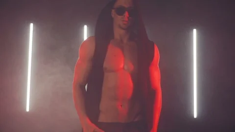 Sexy man dancing in red light Stock Footage 105553165