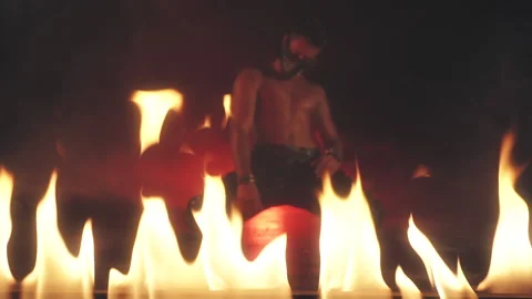 Sexy Man in mask dancing in fire Video stock 140199359