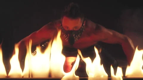Sexy Man in mask dancing in fire Stock Footage 140201027