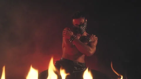 Sexy Man in mask dancing in fire Stock Footage 140201933