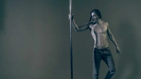 Sexy man pole dancer. Guy does gymnastic exercises on pole dance. Pole dancing Stock Footage 321385922